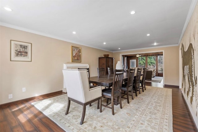 dining area with hardwood / wood-style flooring and crown molding