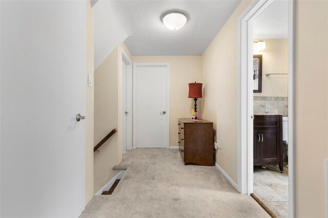 hallway with light colored carpet