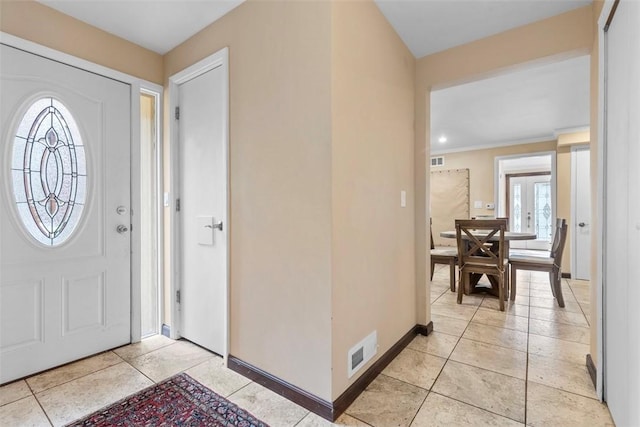 entryway with light tile patterned floors