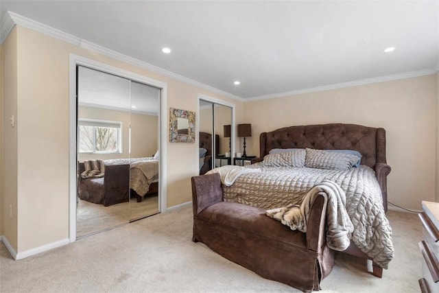 bedroom with multiple closets, ornamental molding, and light colored carpet