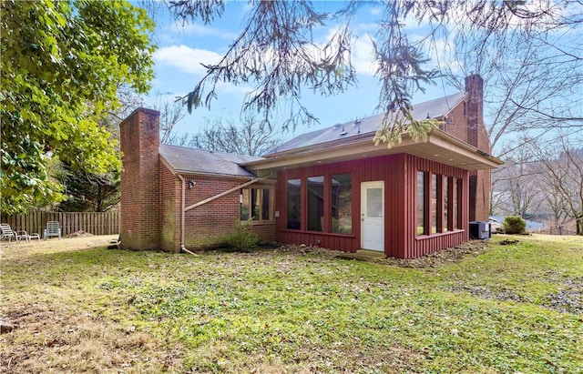 view of side of property featuring cooling unit and a lawn