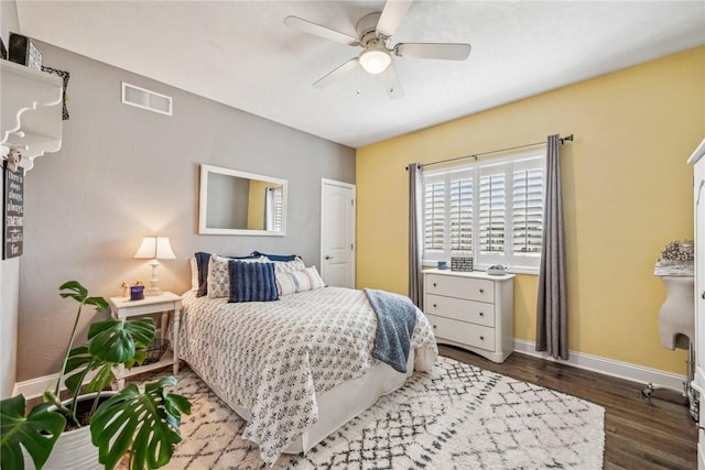 bedroom with ceiling fan and dark hardwood / wood-style flooring