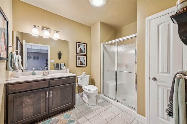 bathroom featuring tile patterned flooring, vanity, an enclosed shower, and toilet