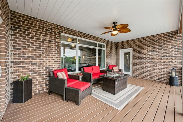 wooden terrace featuring an outdoor living space with a fire pit and ceiling fan