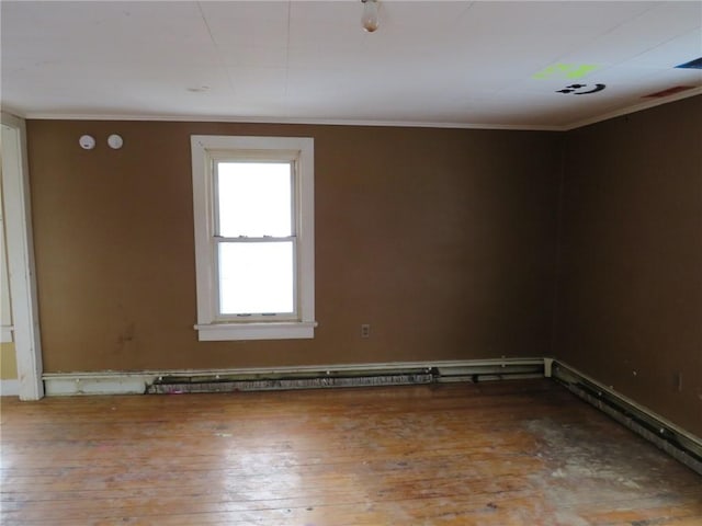 spare room with hardwood / wood-style flooring, a baseboard radiator, and ornamental molding