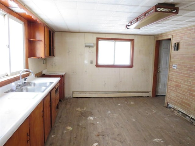 kitchen featuring dark hardwood / wood-style floors, plenty of natural light, sink, and baseboard heating