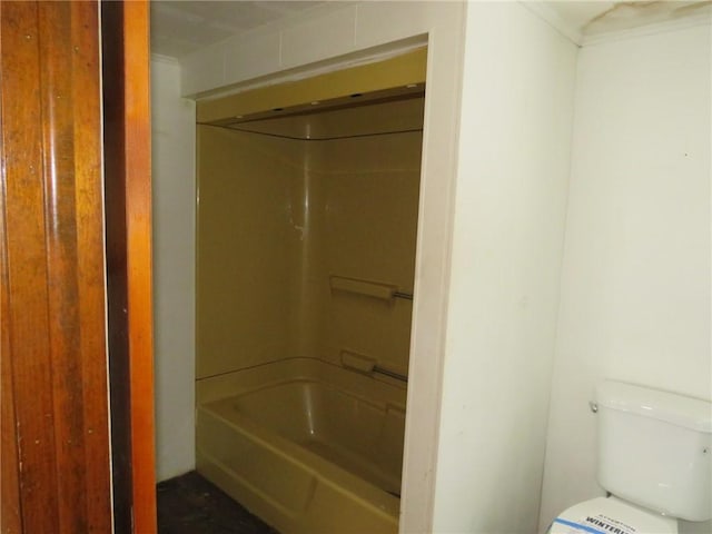 bathroom featuring shower / tub combination and toilet