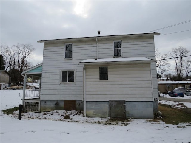 snow covered property featuring a porch