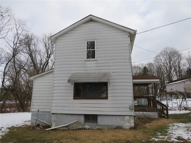 snow covered property featuring covered porch