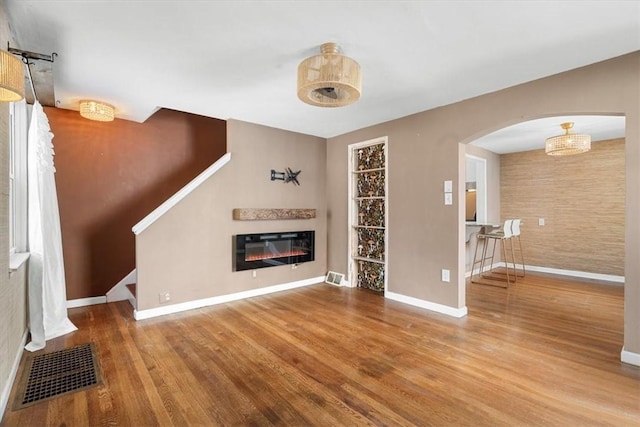 unfurnished living room with hardwood / wood-style flooring