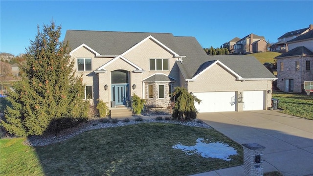 view of front of house featuring a garage and a front lawn