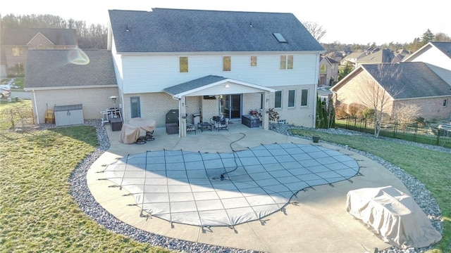 back of property featuring a yard and a patio area