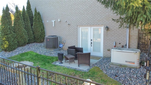 exterior space with french doors, cooling unit, a lawn, and a patio area