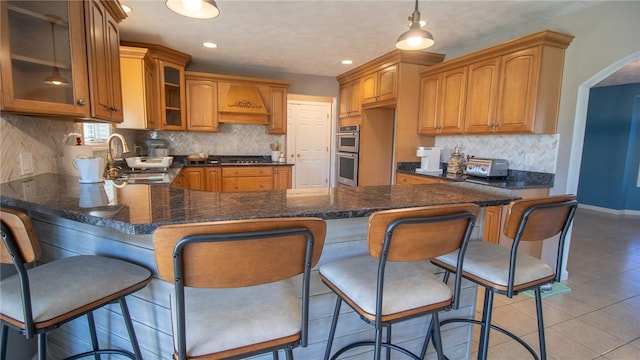 kitchen with pendant lighting, a kitchen breakfast bar, and kitchen peninsula