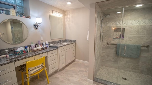 bathroom featuring vanity and an enclosed shower