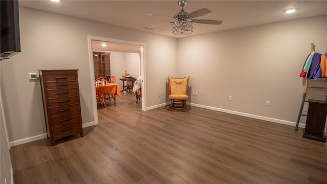 sitting room featuring dark wood-type flooring and ceiling fan