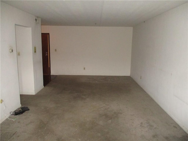 spare room featuring concrete flooring