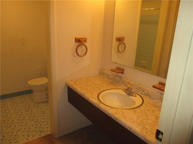 bathroom with vanity, toilet, and walk in shower