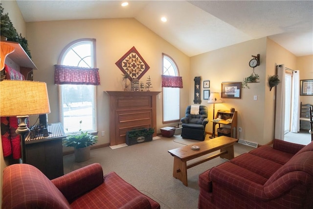 living room with light colored carpet, lofted ceiling, and a wealth of natural light