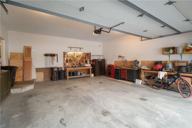 garage featuring a garage door opener and a workshop area