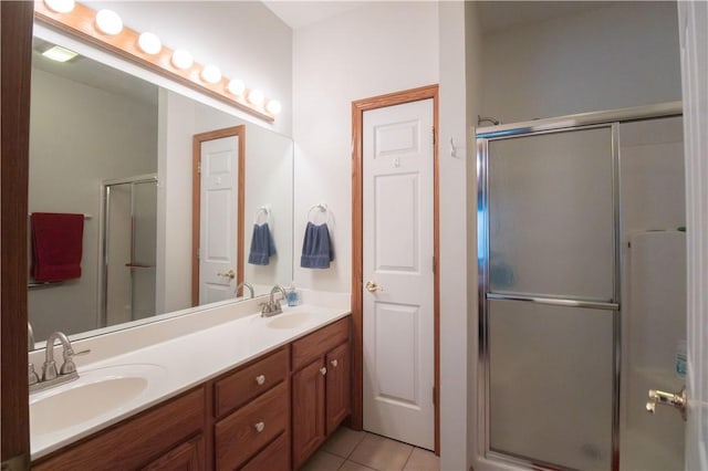 bathroom featuring tile patterned flooring, vanity, and an enclosed shower