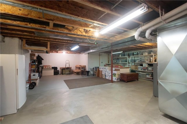 basement featuring white refrigerator