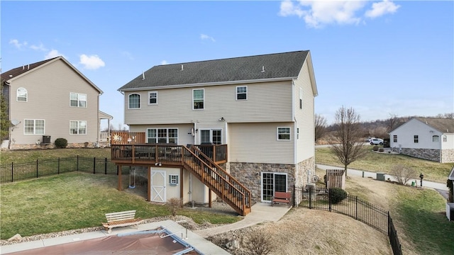 back of property featuring cooling unit, a yard, and a deck