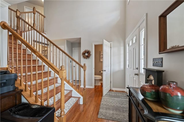 entryway with a high ceiling and light hardwood / wood-style floors