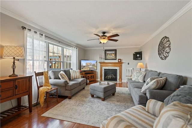 living room with crown molding, ceiling fan, and hardwood / wood-style floors