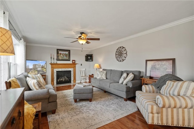 living room with crown molding, ceiling fan, and hardwood / wood-style floors