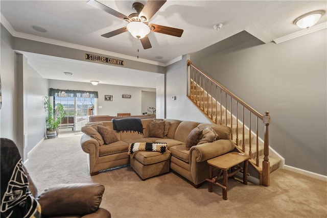 living room with crown molding, light colored carpet, and ceiling fan