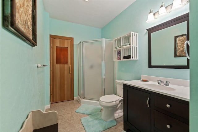 bathroom with vanity, tile patterned floors, a shower with door, and toilet