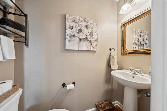 bathroom featuring sink and toilet