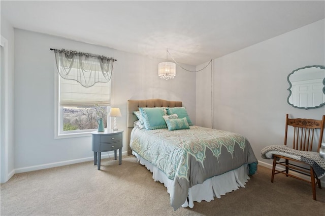 carpeted bedroom featuring an inviting chandelier