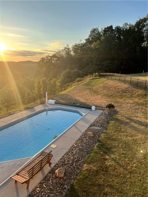 pool at dusk with a lawn