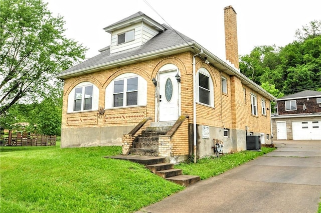 1036 7th St, West Elizabeth, PA 15088 - view of front of house with a chimney, concrete driveway, a front lawn, central AC, and brick siding