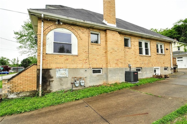 1036 7th St, West Elizabeth, PA 15088 - view of side of home featuring central AC, brick siding, and a chimney