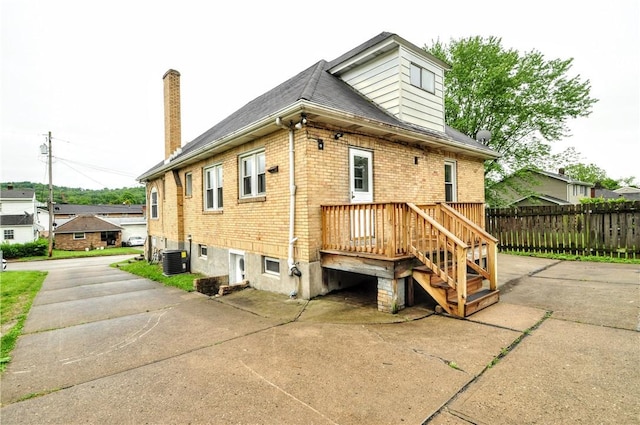 1036 7th St, West Elizabeth, PA 15088 - rear view of house with cooling unit, brick siding, a chimney, and roof with shingles
