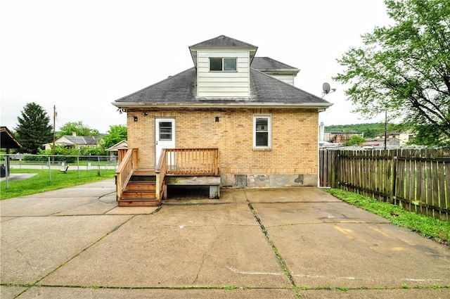 1036 7th St, West Elizabeth, PA 15088 - rear view of house featuring a fenced backyard, brick siding, a deck, a patio, and a shingled roof