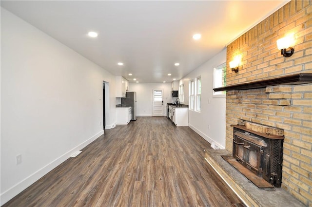 1036 7th St, West Elizabeth, PA 15088 - unfurnished living room with dark wood-style floors, baseboards, a brick fireplace, recessed lighting, and a sink