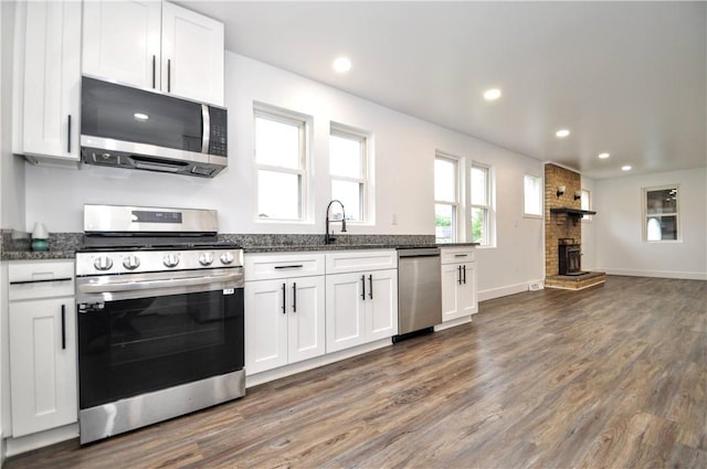 1036 7th St, West Elizabeth, PA 15088 - kitchen featuring appliances with stainless steel finishes, dark stone counters, dark wood-type flooring, and recessed lighting