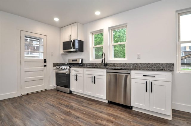 1036 7th St, West Elizabeth, PA 15088 - kitchen featuring appliances with stainless steel finishes, dark stone countertops, dark wood-style flooring, white cabinetry, and baseboards