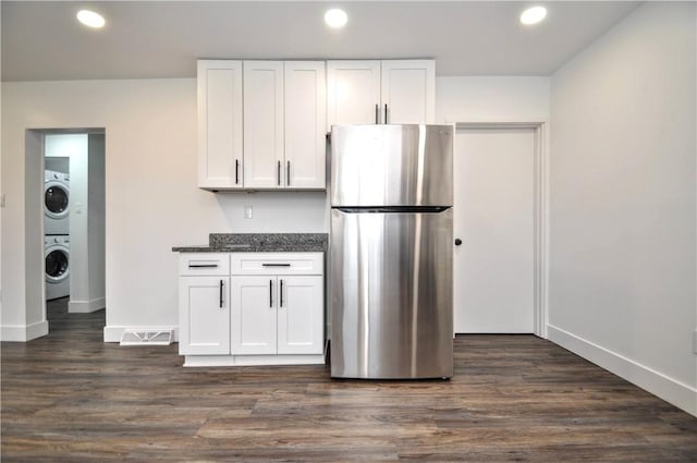 1036 7th St, West Elizabeth, PA 15088 - kitchen featuring freestanding refrigerator, stacked washing machine and dryer, white cabinetry, baseboards, and recessed lighting