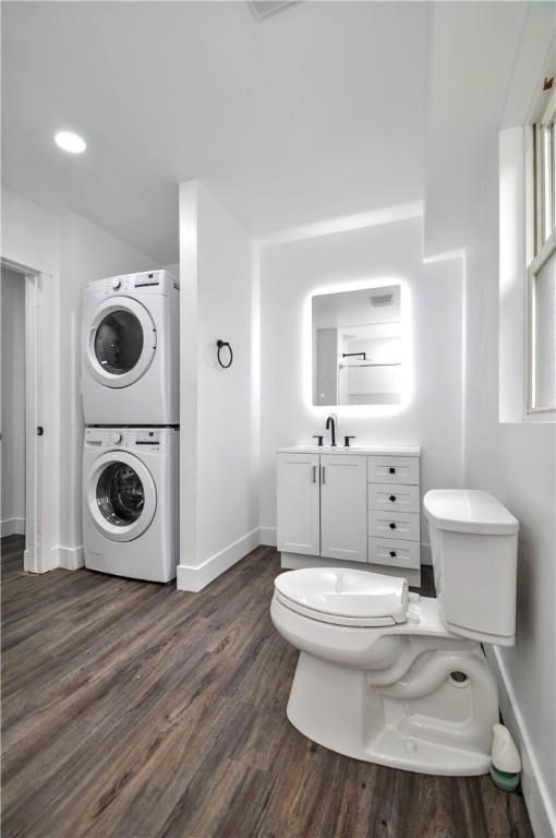 1036 7th St, West Elizabeth, PA 15088 - bathroom with stacked washer and clothes dryer, toilet, baseboards, wood finished floors, and vanity