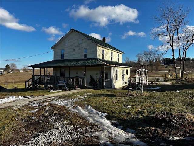 back of house featuring a porch and a yard