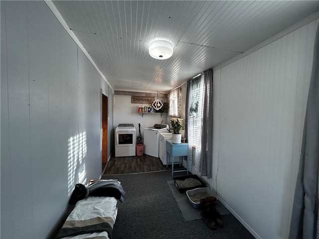 clothes washing area with dark carpet and independent washer and dryer