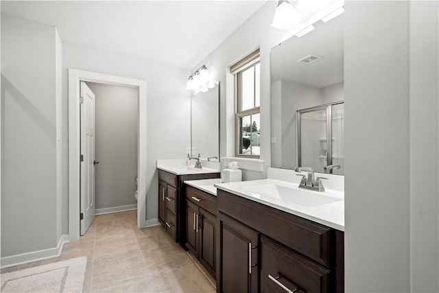 full bathroom featuring two vanities, a sink, visible vents, and a shower stall