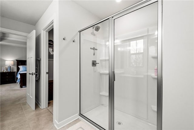 ensuite bathroom with a stall shower, tile patterned flooring, and ensuite bath