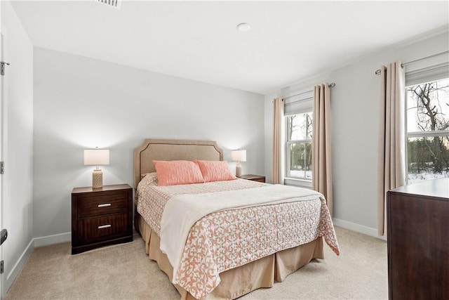 bedroom with light carpet and baseboards