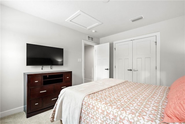 carpeted bedroom with attic access, a closet, visible vents, and baseboards